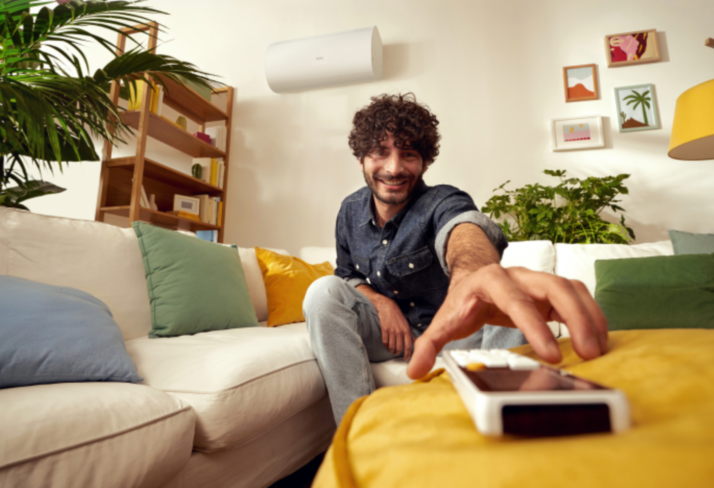 Un ragazzo che prende il telecomando del condizionatore