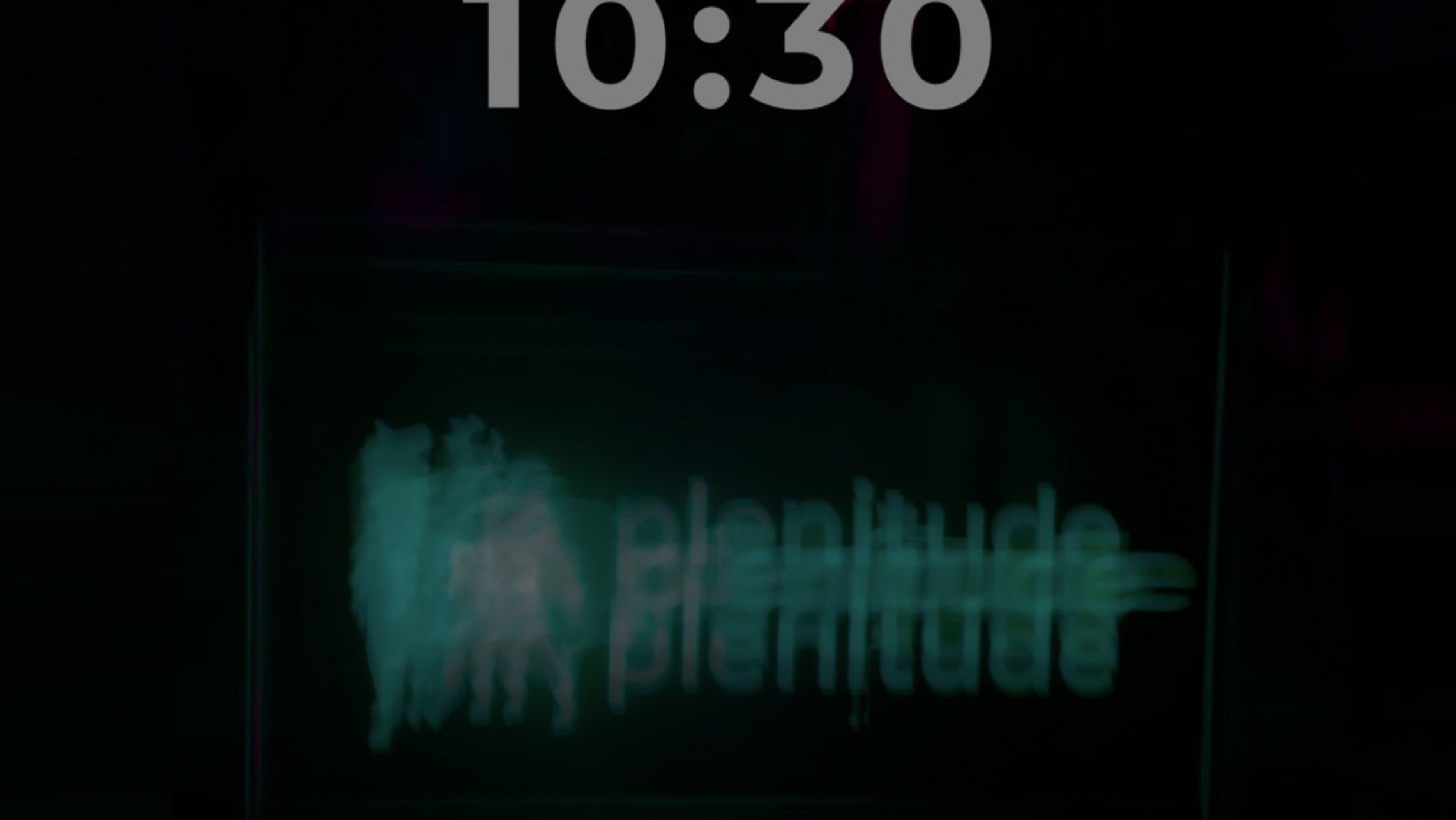 Lo sfondo di un telefono con la foto di un neon con la scritta e il logo di Plenitude in verde.