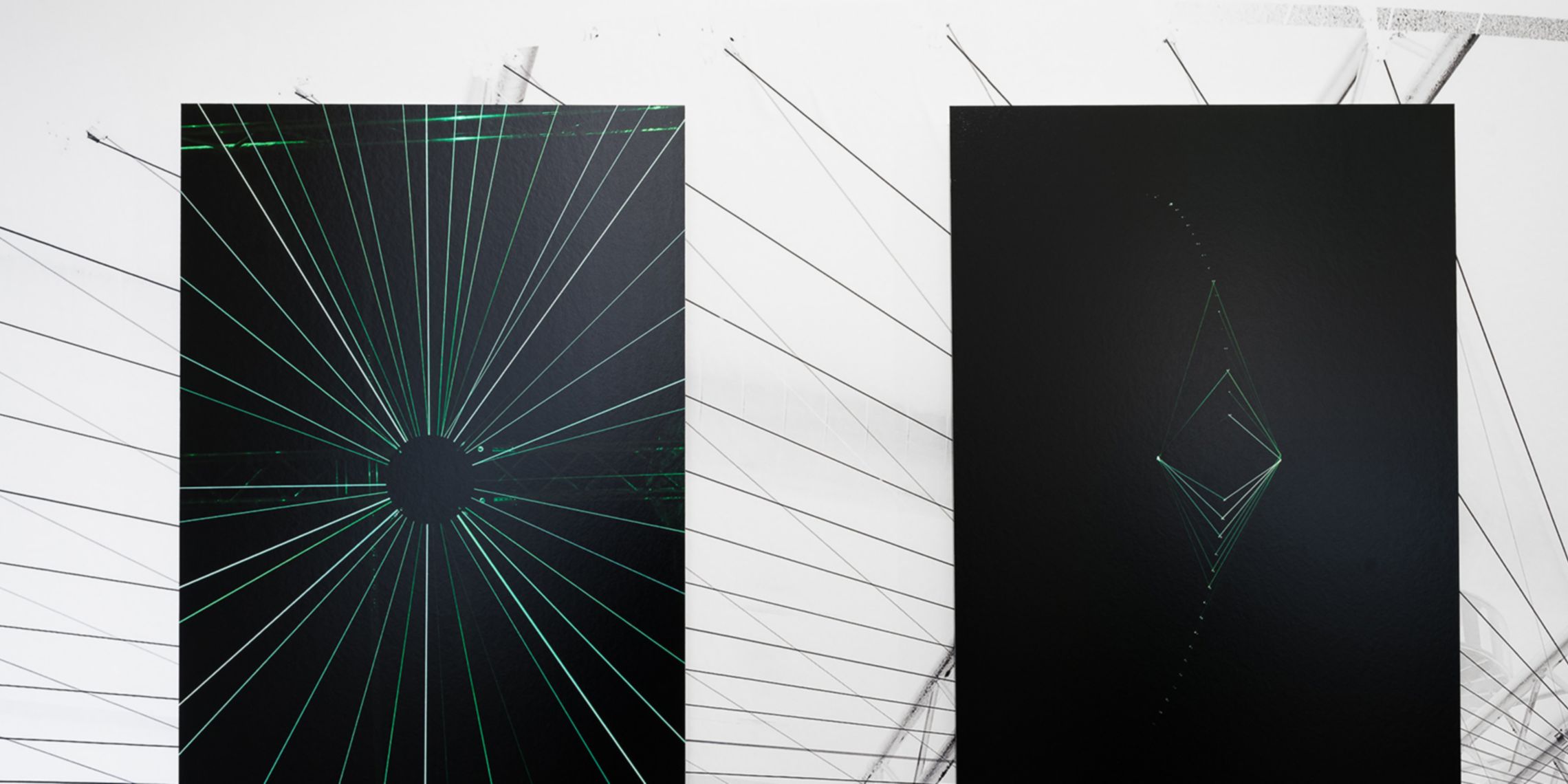 Two of the paintings exhibited at CAMERA, both featuring a black background and green light details