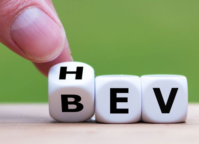 Hand arranging letter cubes on green background 