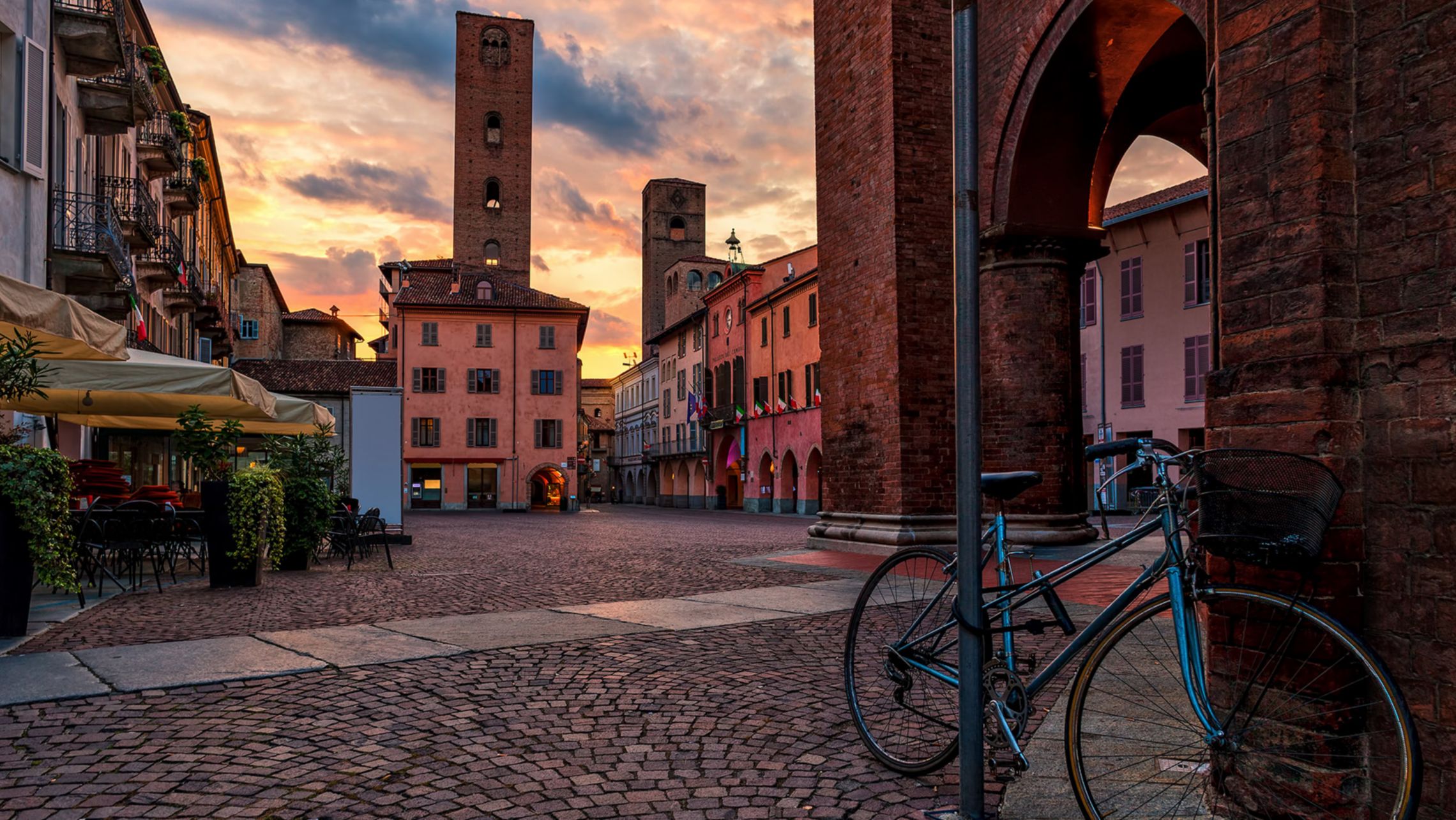 Bicycle on cobblestone town square in Alba, Piedmont, Northern Italy.